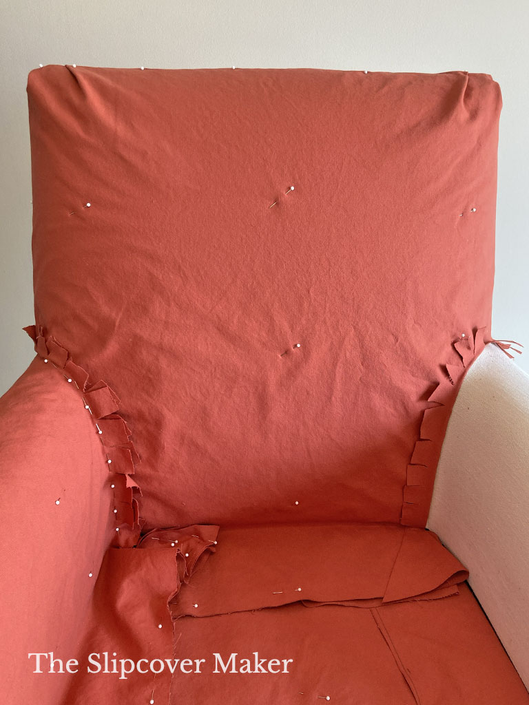 Orange canvas chair slipcover with poor fit.
