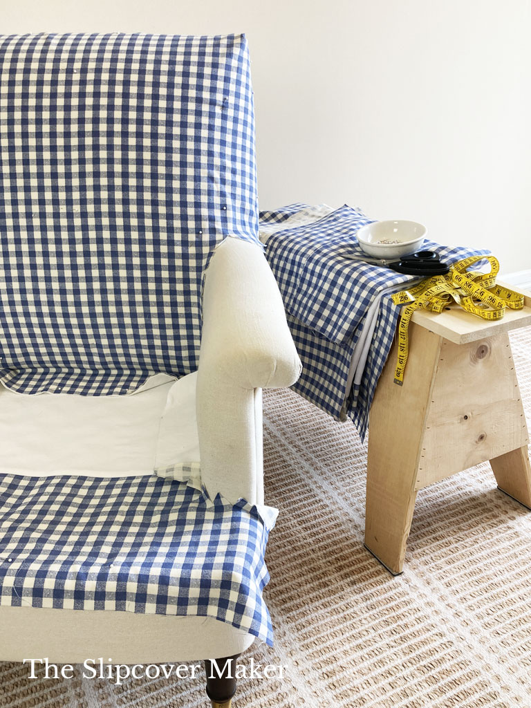 Pin fitting armchair with blue gingham fabric.