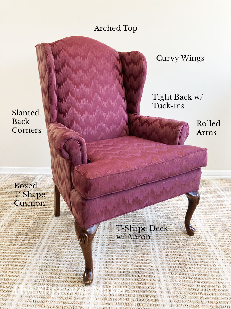 Burgandy upholstered wingback chair.