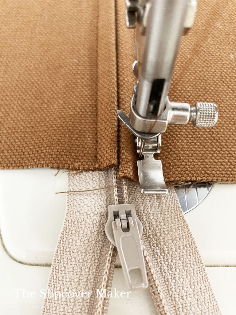 Stitching zipper to panel for slipcover.