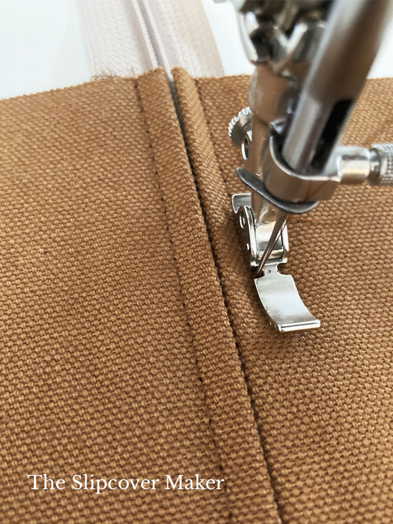 Stitching zipper to panel.