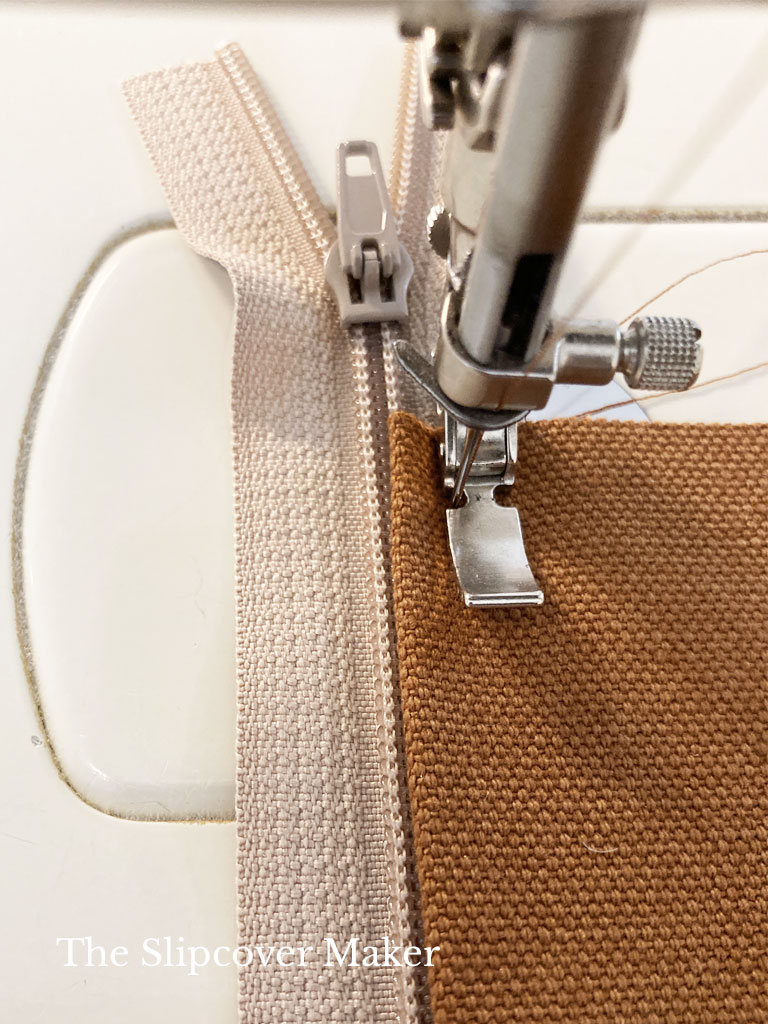 Stitching zipper to panel.