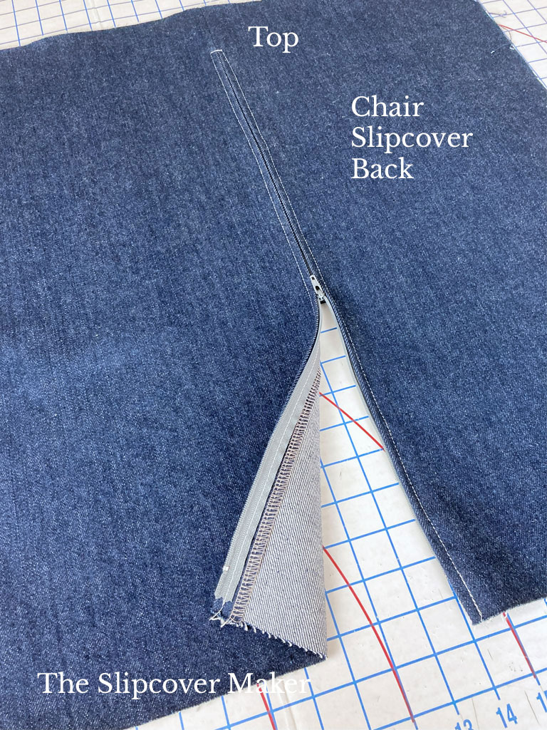 Blue denim slipcover back with centered zipper.