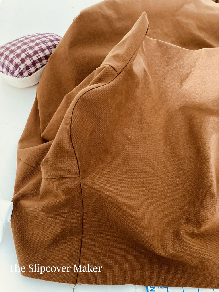 Smooth slipcover arm seam after pressing.