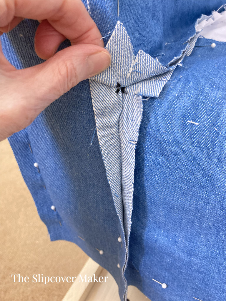 Marking a sewing point on a slipcover.