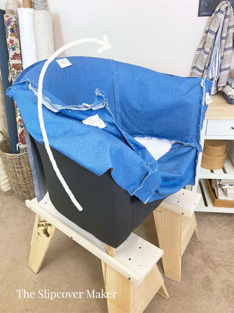 Removing slipcover from chair.